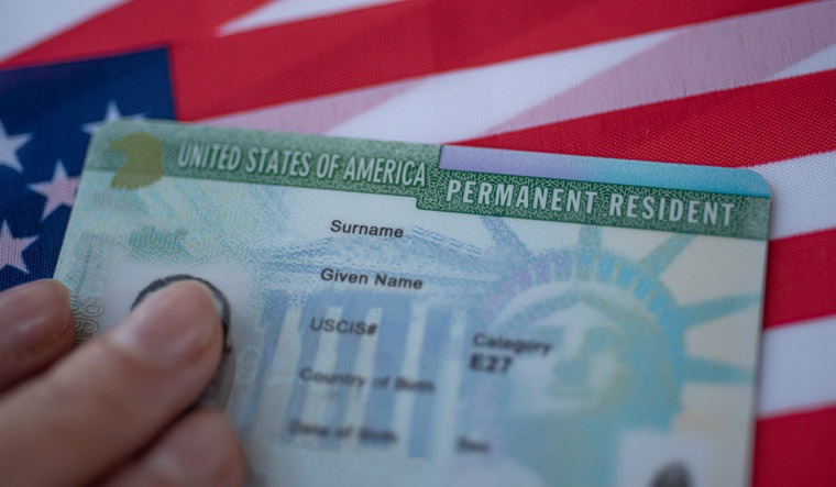 Person holding their green card